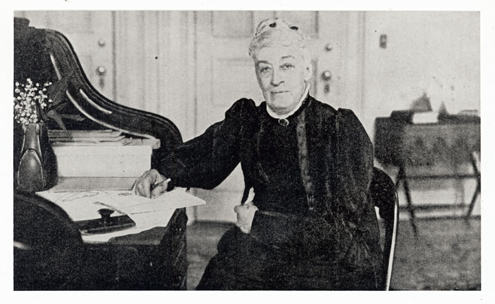Margaret O. Sage at desk